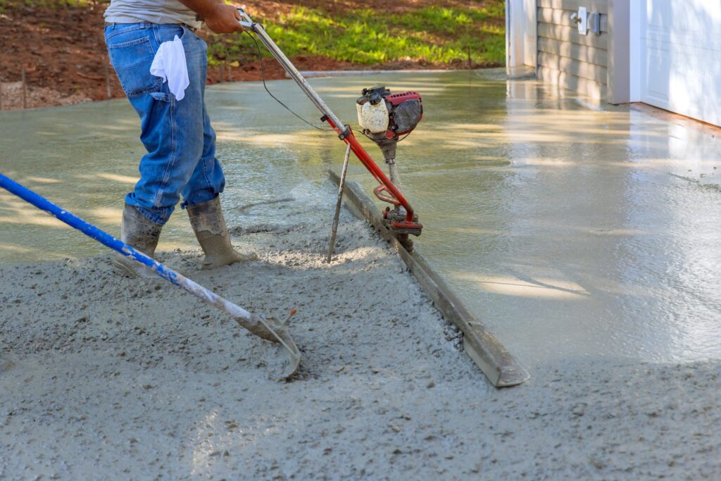 Utilizing tamping machine to align compacted concrete on driveways